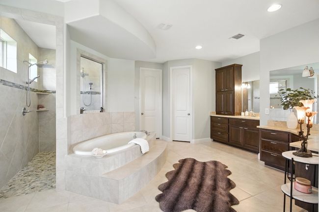 Bathroom with a garden tub, vanity, a walk in shower, tile patterned floors, and recessed lighting | Image 18