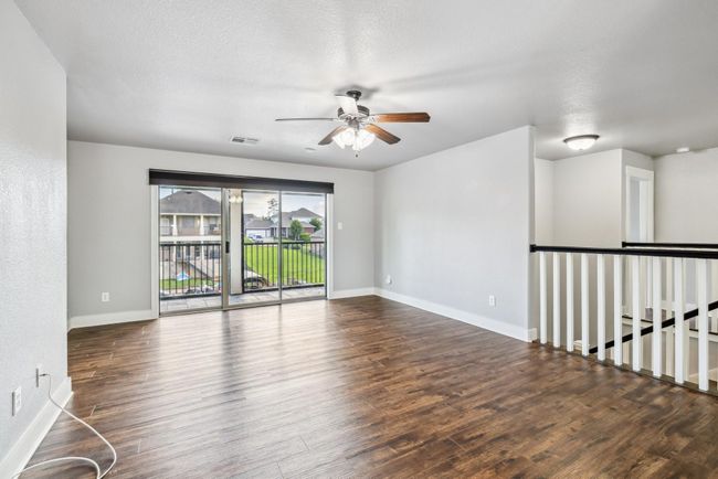 Oversized game room upstairs with view of the water and balcony access | Image 22