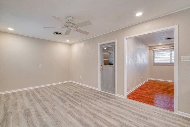 Another view of Dining room with a ceiling fan, recessed lighting, 2024 laminate flooring, and baseboards and garage access entry | Image 9