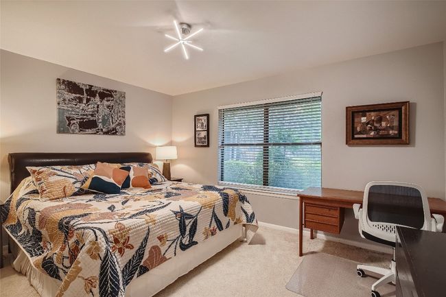 Carpeted bedroom featuring baseboards and a desk | Image 6