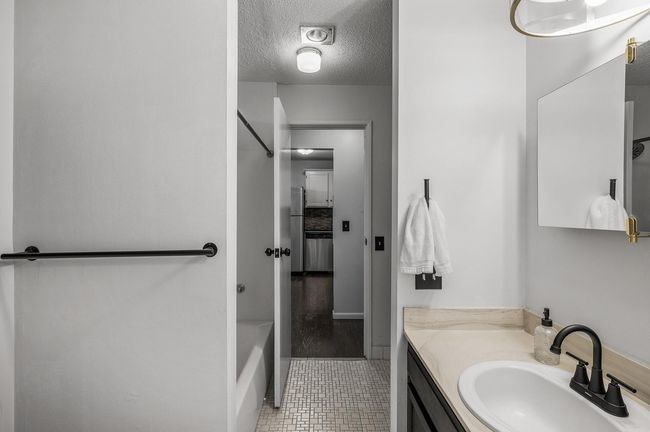 The bathroom has modern hardware, updated mirrors and light fixtures you're sure to love! | Image 17