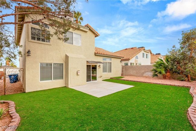 Back of house featuring a patio area, a fenced backyard, a yard, and stucco siding | Image 6