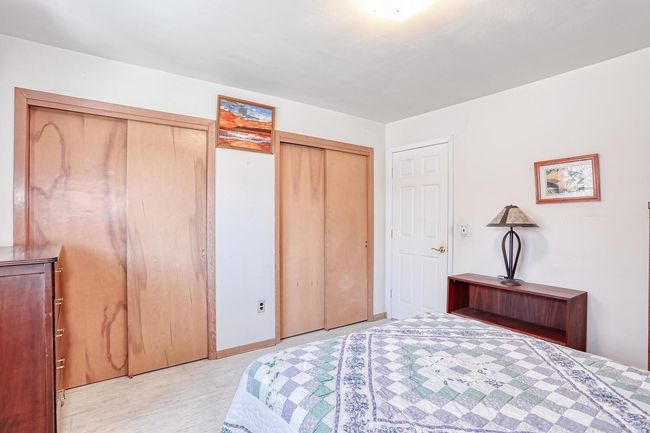 Bedroom featuring light wood-type flooring and multiple closets | Image 23
