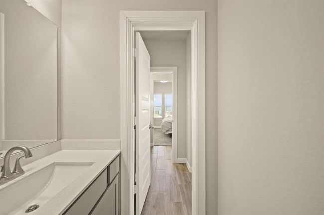 Jack-and-Jill style bathroom with sleek vanity and modern finishes, connecting two spacious bedrooms. | Image 32