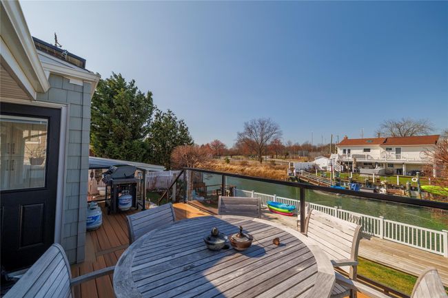 Wooden deck with a water view and outdoor dining area | Image 30