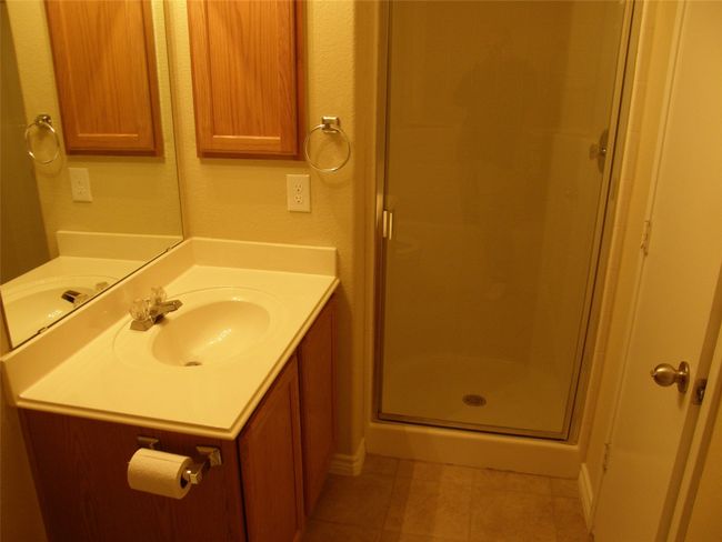 Full bath with tile patterned flooring, a shower stall, and vanity | Image 11