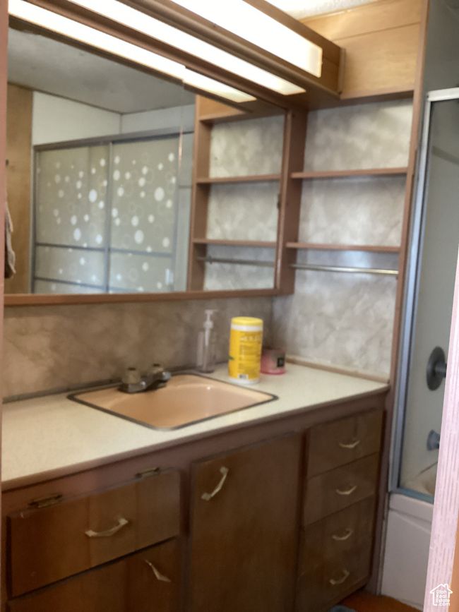 Kitchen featuring a sink, light countertops, open shelves, and backsplash | Image 23