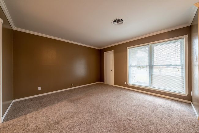 Spare room featuring crown molding and carpet floors | Image 16