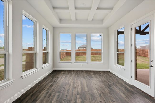 Unfurnished sunroom with coffered ceiling, baseboards, wood finished floors, and beam ceiling | Image 8