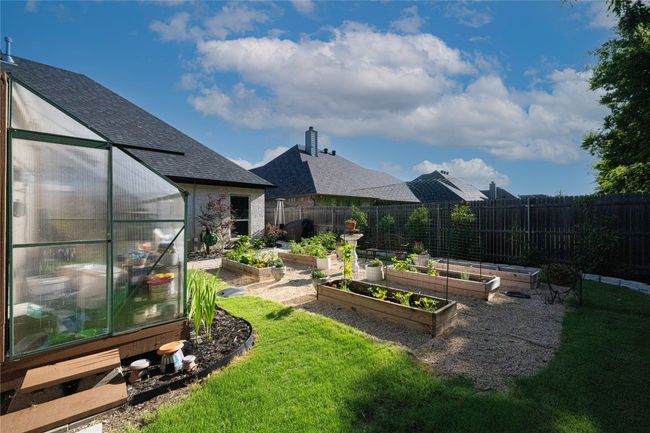 View of yard with an exterior structure, a garden, and an outbuilding | Image 29