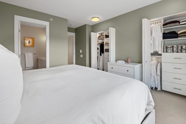 Carpeted bedroom featuring a spacious closet, ensuite bath, and a closet | Image 25