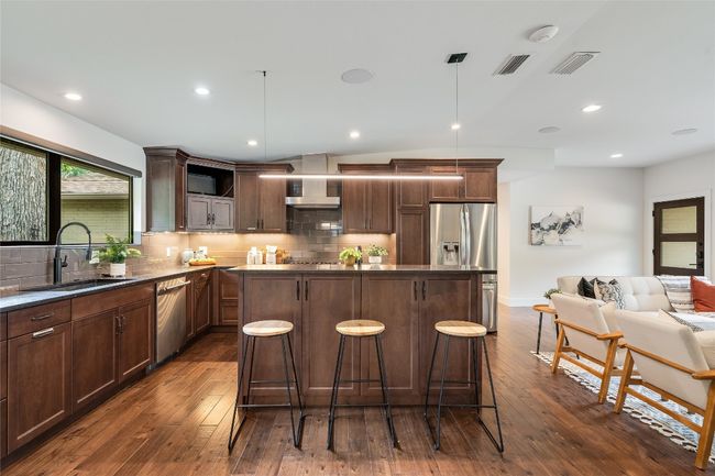The home chef will love all of the counter space and cabinetry storage including cabinets on the back of the island, a custom spice drawer, and soft close drawers. | Image 17