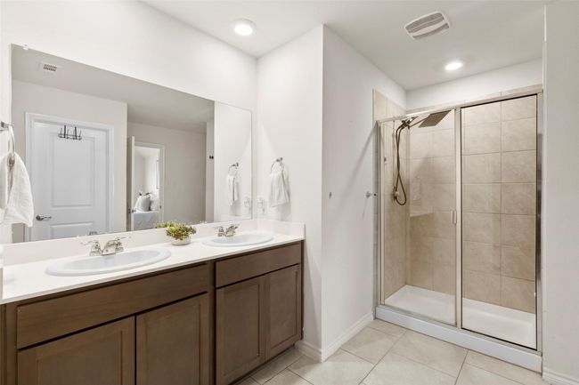 Ensuite bathroom with tile patterned flooring, visible vents, a sink, and connected bathroom | Image 15