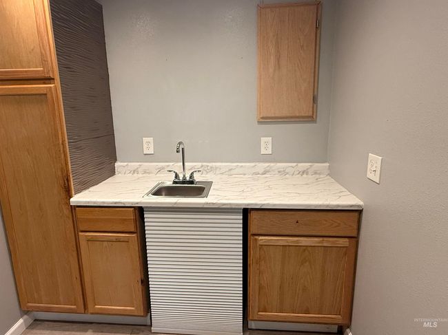 Bar with a sink and baseboards | Image 24