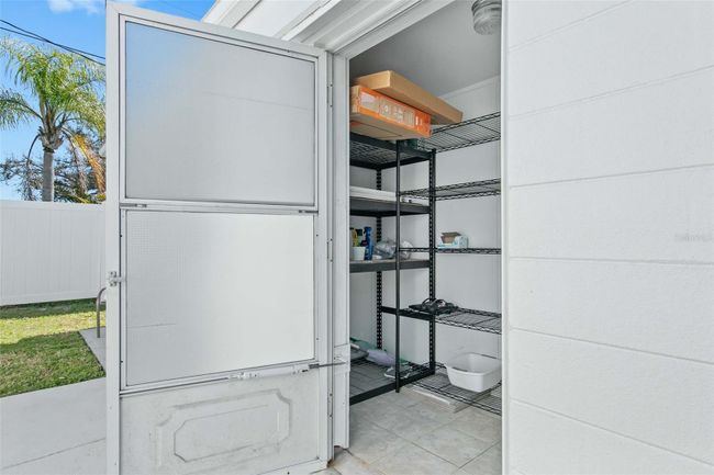 There is a laundry room (washer/dryer not pictured) that also provides additional storage space. | Image 22