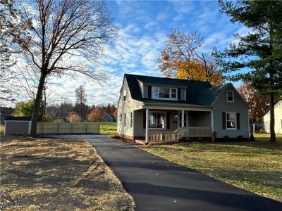 Bungalow-style house with a porch and a front lawn | Image 2