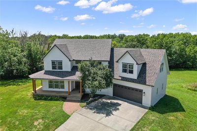 View of front of home featuring covered porch, a garage, and a front lawn | Image 2