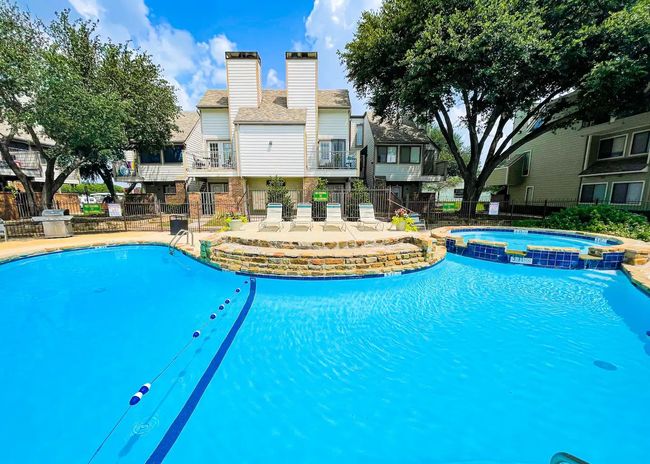 View of pool featuring fence, a residential view, and a pool with connected hot tub | Image 17