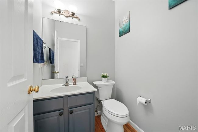 Half bathroom featuring vanity and wood finished floors | Image 23