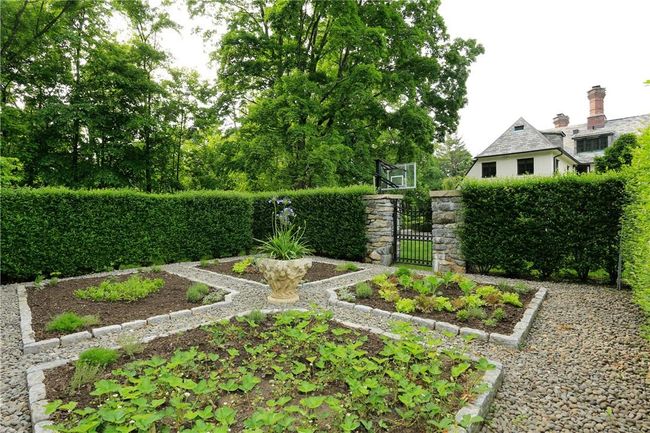 Fenced vegetable garden with hedgerow, stone pillars and iron gated entry | Image 7