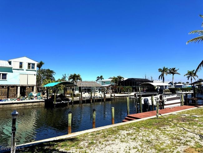 Dock area with a water view and boat lift | Image 31