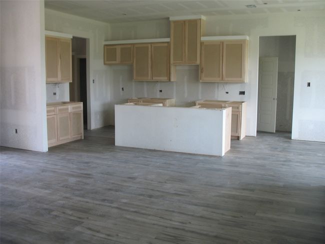 Kitchen with a center island and dark wood finished floors | Image 8