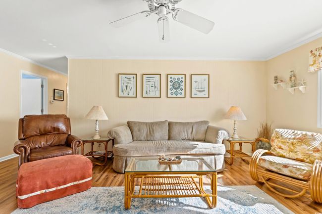 Living room featuring ceiling fan, ornamental molding, and hardwood / wood-style flooring | Image 11