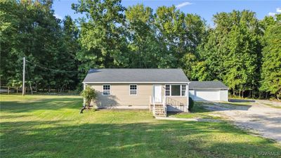 View of front facade with a garage and a front yard | Image 2