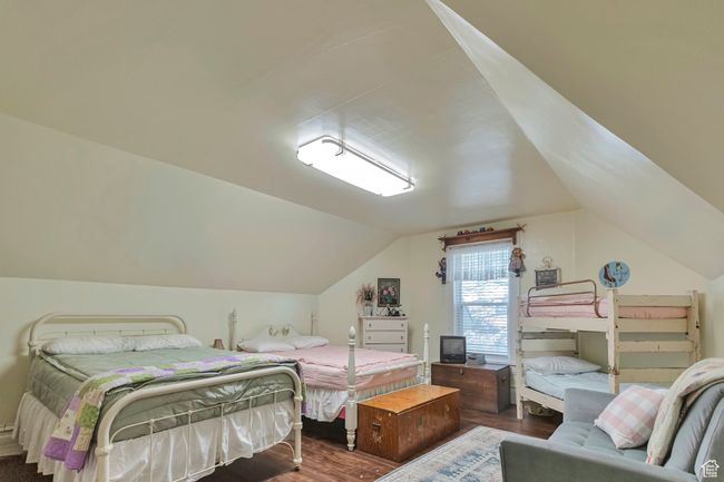 Bedroom featuring dark wood-type flooring and lofted ceiling | Image 27