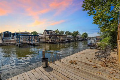 Extensive decking leads to the water and out to the lake you go. Swimming platform is a great feature! | Image 3