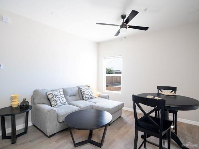 Living room featuring ceiling fan and light hardwood / wood-style flooring | Image 5