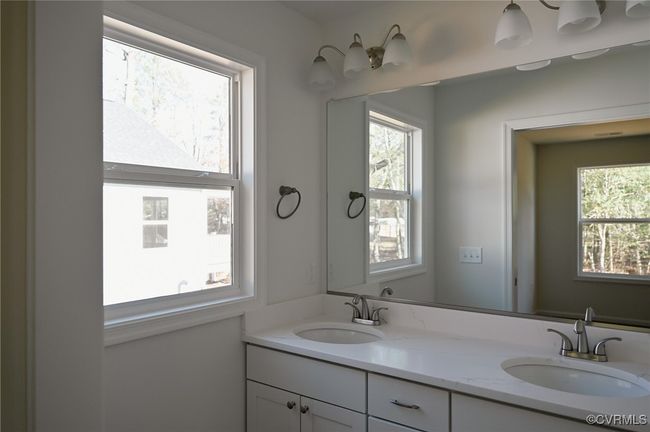 Bathroom featuring vanity and a wealth of natural light | Image 12