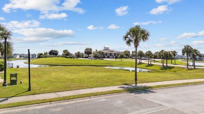 View of community with a yard and a water view | Image 1