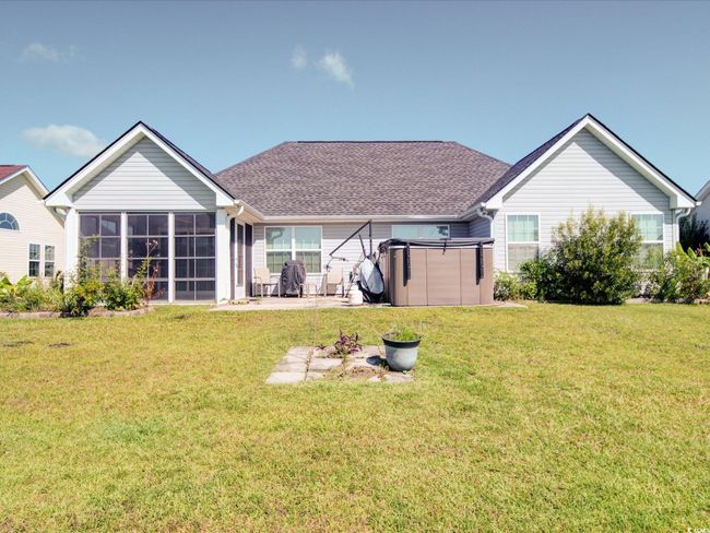 Back of property featuring a sunroom, a yard, a patio area, and roof with shingles | Image 6