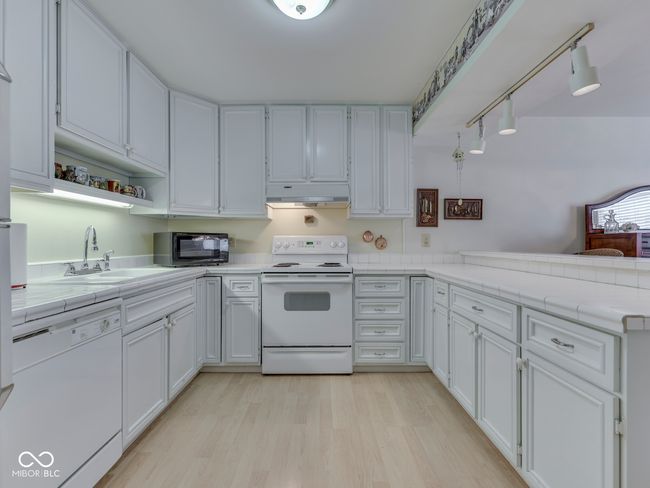 Great storage space with these cabinets that go all the way to the ceiling | Image 18