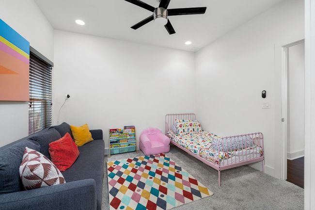 Carpeted bedroom featuring a ceiling fan and recessed lighting. | Image 11