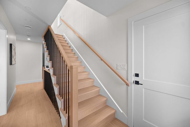 Stairs featuring wood finished floors and recessed lighting | Image 18