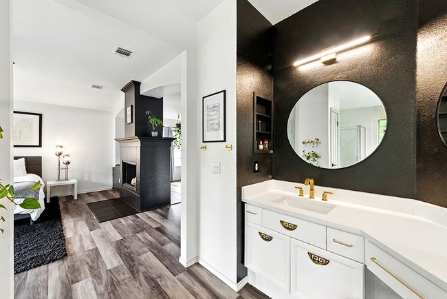 Ensuite bathroom featuring vaulted ceiling, a bath, a stall shower, wood finished floors, and vanity | Image 28