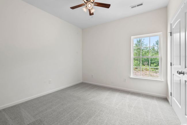 Carpeted spare room featuring a ceiling fan and baseboards | Image 14
