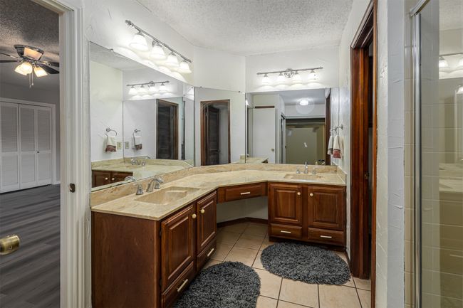 Bathroom featuring ceiling fan, a sink, and a textured ceiling | Image 8