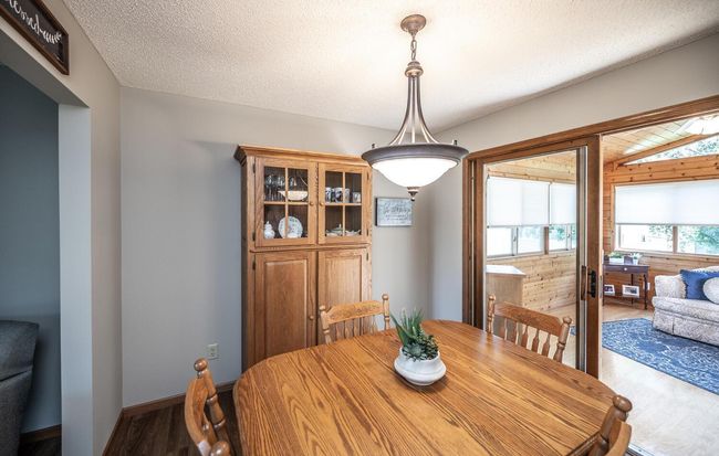 Dining room with sliding glass door to porch. | Image 12