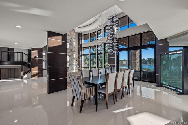 Dining area featuring light tile patterned floors, plenty of natural light, recessed lighting, and stairs | Image 6