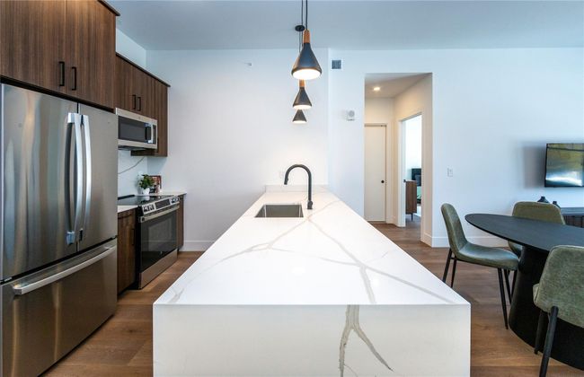 Corian quartz countertops, backsplash and waterfall island. | Image 13