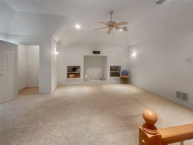 Unfurnished living room with vaulted ceiling, ceiling fan, and baseboards | Image 19