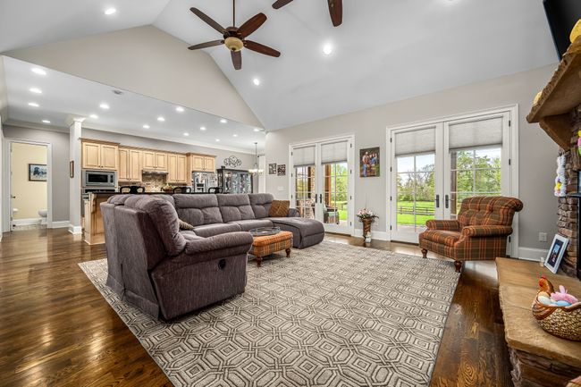 The heart of the home is often considered the place where warmth, comfort, and togetherness converge, and a large family room with a gas log fireplace and hardwood floors perfectly embodies this concept. | Image 35