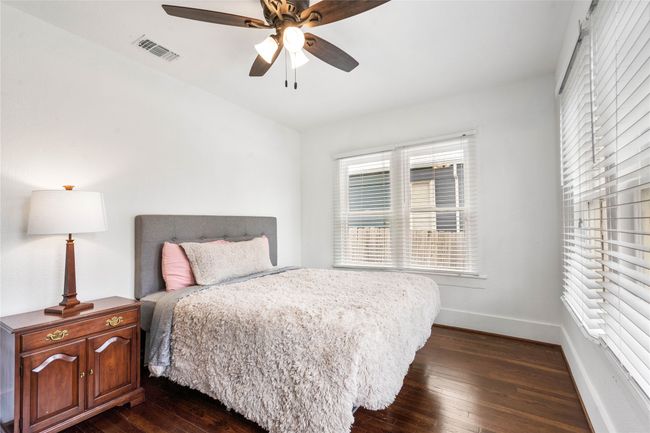 Bedroom with dark wood finished floors and ceiling fan | Image 22