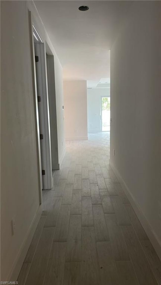 Foyer front entrance with additional bedroom (on left) and lead-in to kitchen and great room (on right) | Image 4