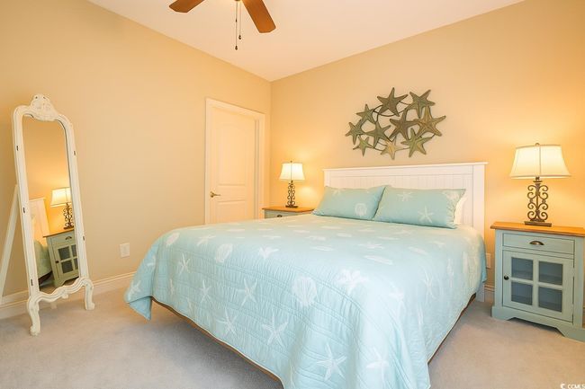 Bedroom with carpet flooring and a ceiling fan | Image 20
