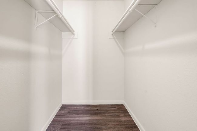 Walk in closet with wood finished floors | Image 12