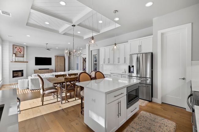 Kitchen facing towards the front door. Primary bedroom is towards the back left of image | Image 6
